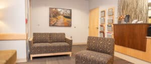 Clinic waiting room – Interior of Alpine Surgical with chairs, decor, and wall art
