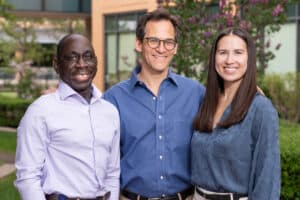 Alpine Surgical team – Two male surgeons and one female staff member standing in front of clinic building