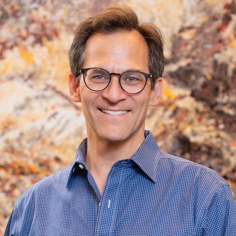 Dr Fox with glasses posing in blue button-down shirt in clinic. Veneers in Green Village ,NJ. Vaccaro Aesthetic and Family Dentistry in Green Village, NJ.