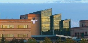 Modern hospital building with cross symbol, representing advanced surgical facilities.